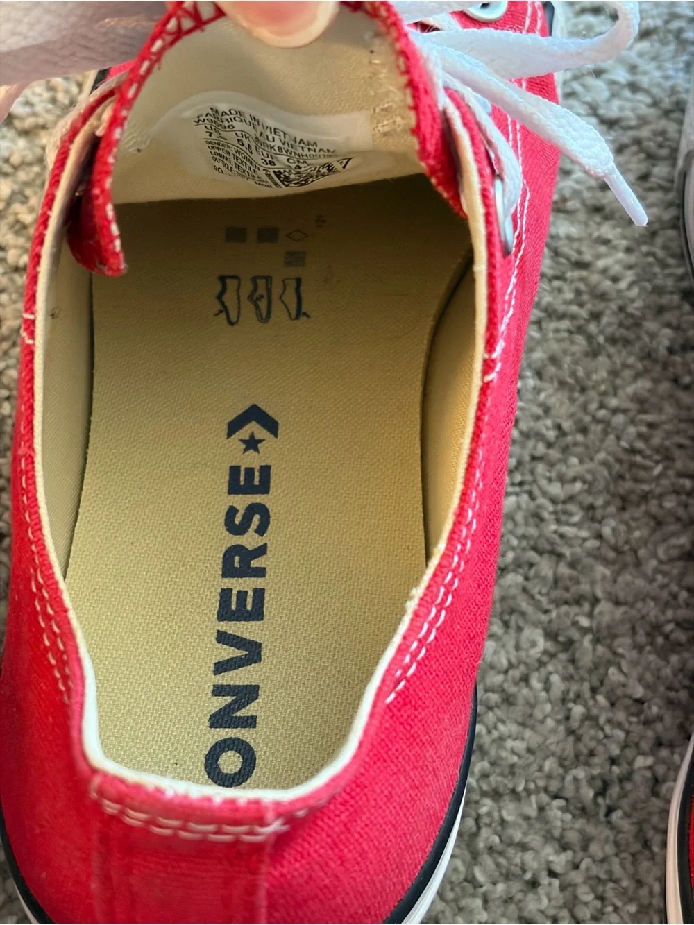 Converse red low-top sneakers with white laces